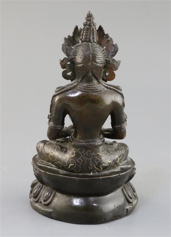 A Tibetan silver and gold inlaid copper alloy figure of Amitayus/Amitabha, c.15th century, H. 20.5cm